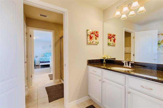 bathroom featuring vanity, a shower with door, tile patterned flooring, and toilet