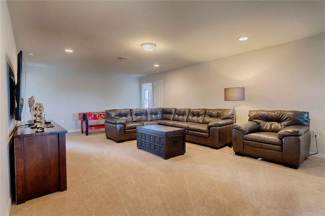 carpeted living room featuring a textured ceiling