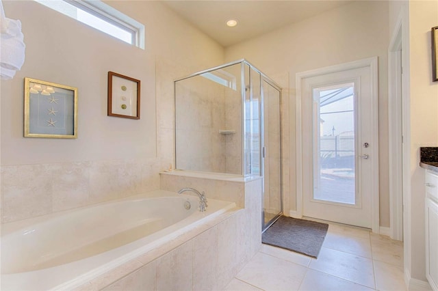 bathroom with tile patterned flooring, shower with separate bathtub, and vanity