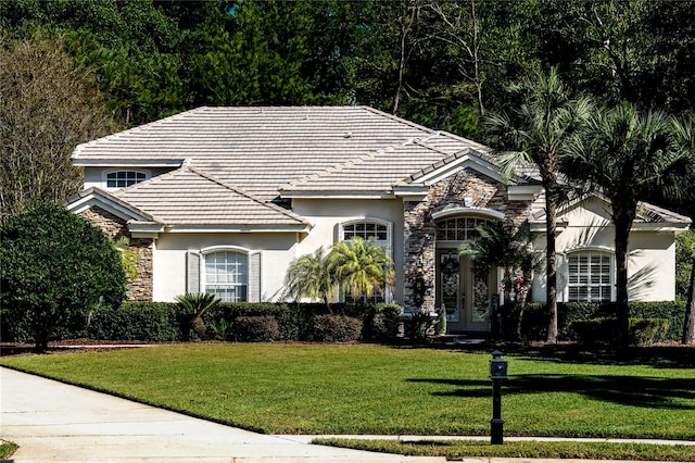 view of front facade with french doors and a front lawn