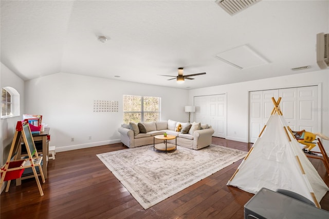 living area with attic access, visible vents, and dark wood finished floors