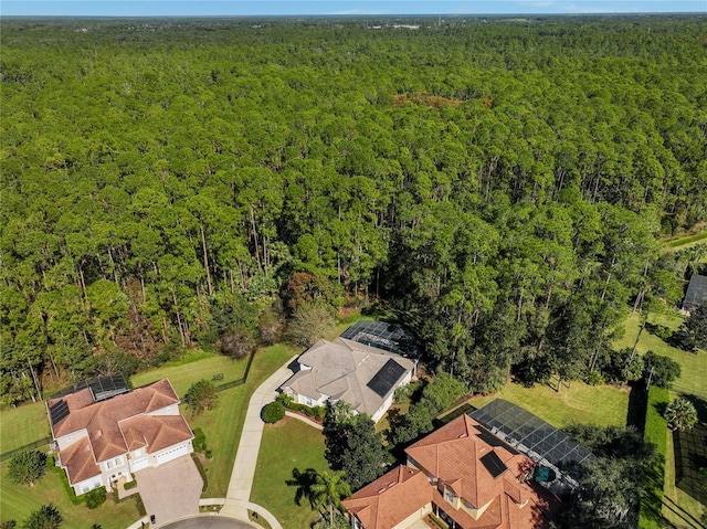 birds eye view of property featuring a wooded view