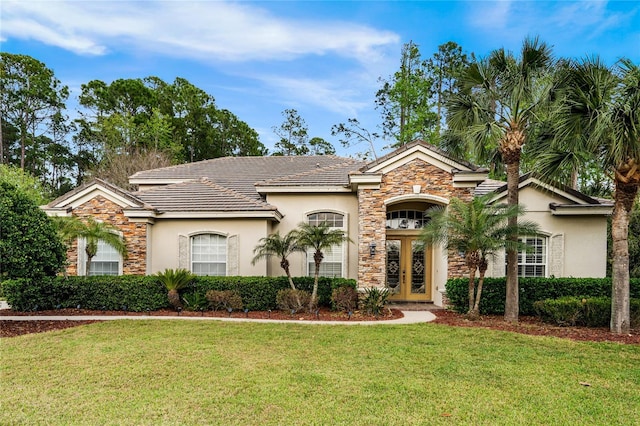 view of front of property with stone siding, french doors, a front lawn, and stucco siding