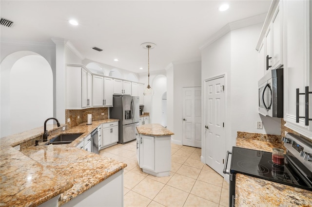 kitchen featuring arched walkways, appliances with stainless steel finishes, ornamental molding, a sink, and light stone countertops