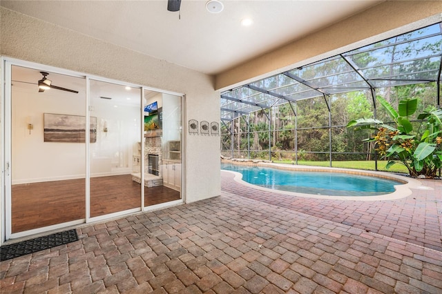 pool featuring a patio area and glass enclosure