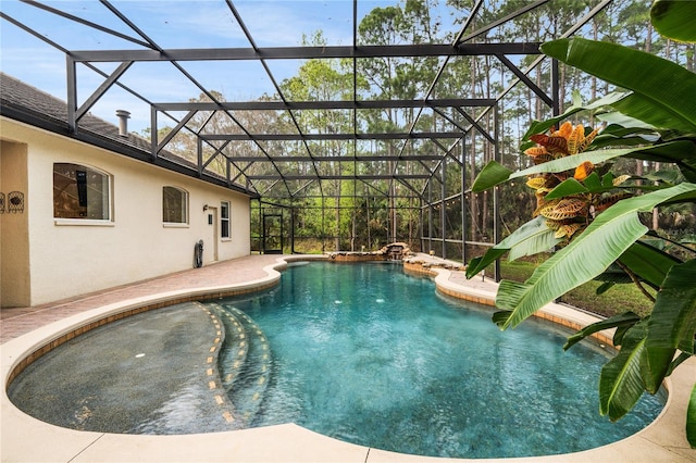 pool featuring glass enclosure and a patio