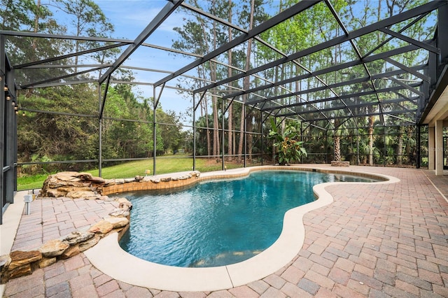 outdoor pool featuring glass enclosure and a patio area