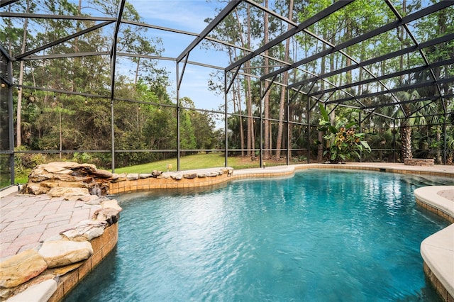 outdoor pool featuring a lanai and a patio area