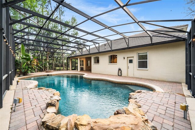 pool featuring a lanai and a patio