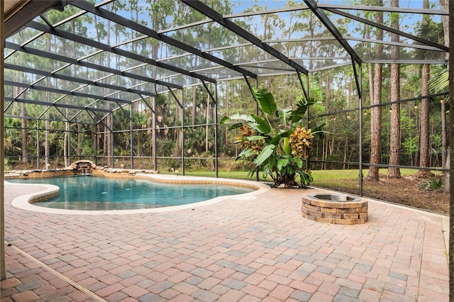 outdoor pool with a lanai, a patio, and a fire pit