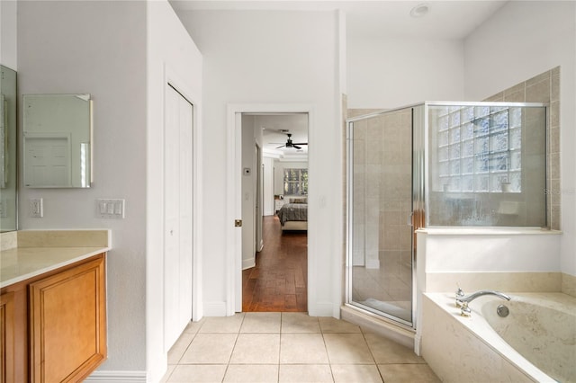 ensuite bathroom featuring a stall shower, connected bathroom, a garden tub, tile patterned flooring, and vanity