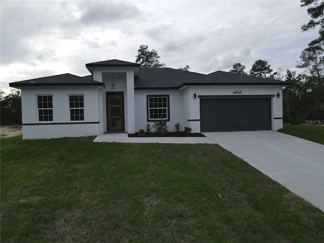 view of front of property with a garage and a front yard