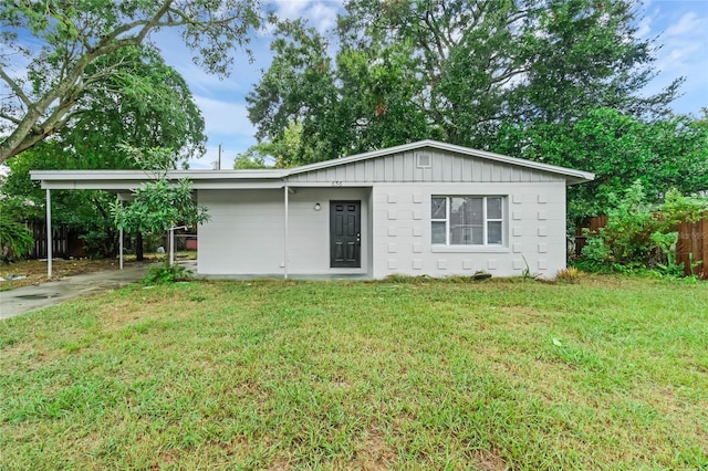 exterior space featuring a front lawn and a carport