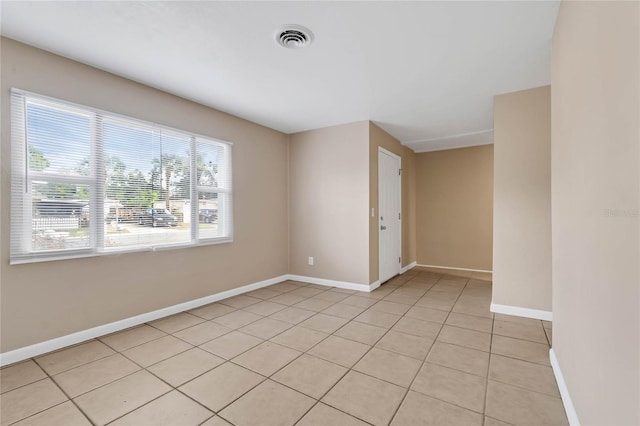 empty room with light tile patterned floors