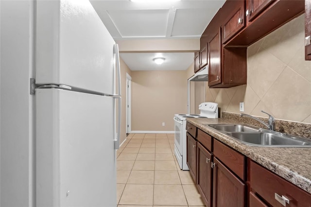 kitchen featuring light tile patterned floors, white appliances, and sink