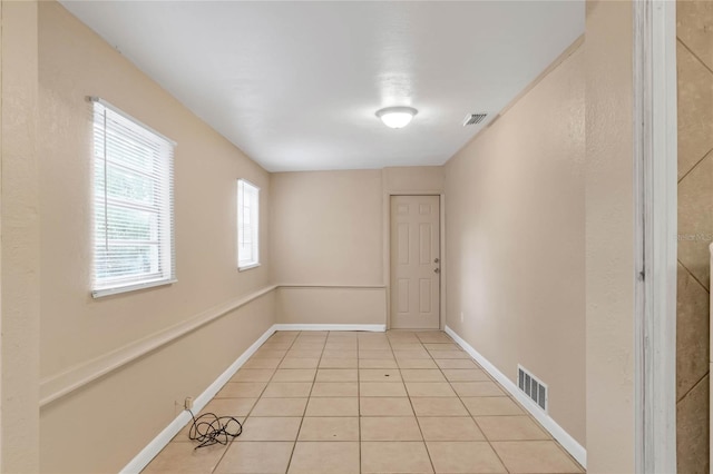 spare room featuring light tile patterned floors