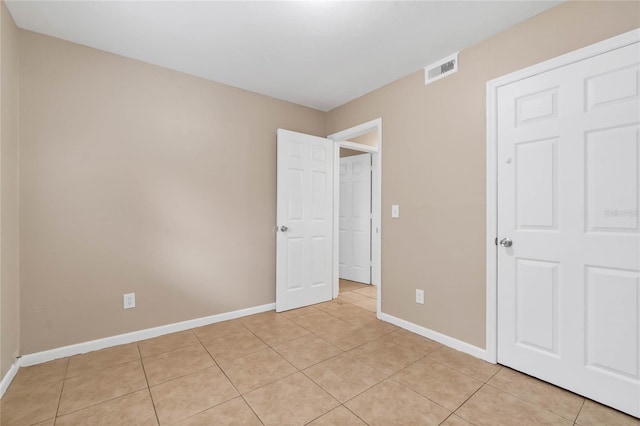 unfurnished bedroom featuring light tile patterned floors