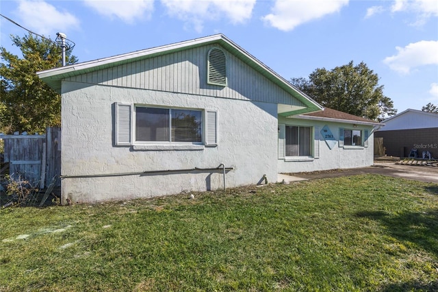 view of side of property with a yard