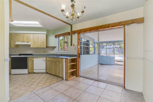 kitchen featuring white appliances, backsplash, sink, decorative light fixtures, and a notable chandelier