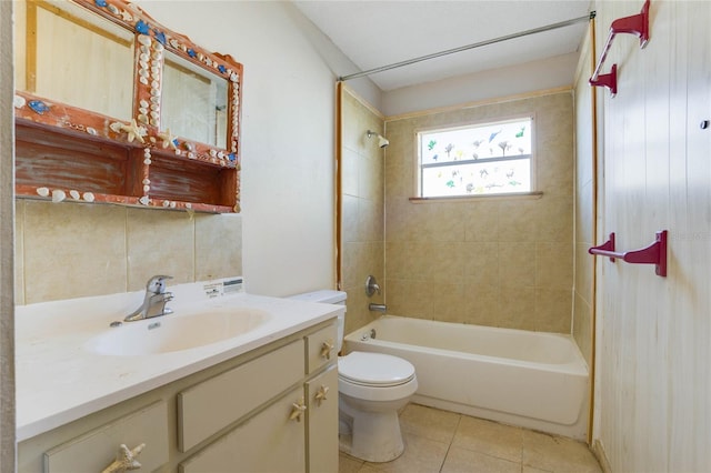 full bathroom featuring tile patterned floors, tiled shower / bath combo, toilet, and vanity