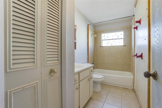 full bathroom with tile patterned floors, vanity, tiled shower / bath combo, and toilet