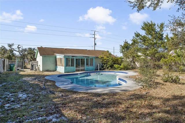 view of pool with a sunroom