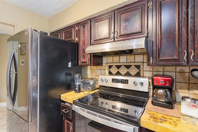 kitchen with stainless steel appliances and tasteful backsplash