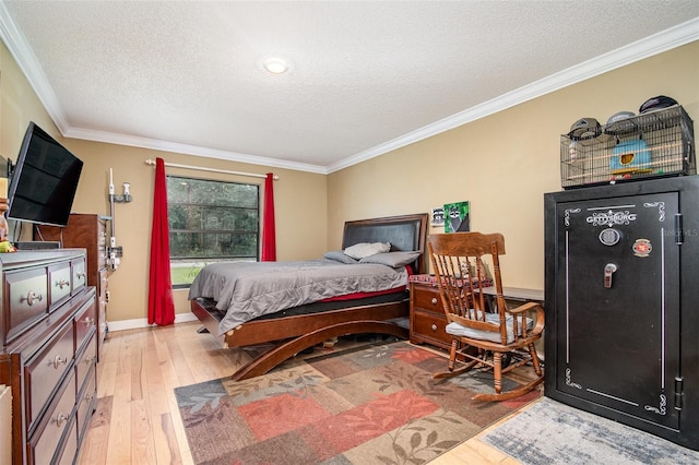 bedroom with crown molding, a textured ceiling, and light wood-type flooring