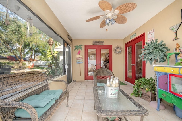 sunroom / solarium featuring french doors and ceiling fan