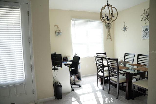 dining room with light carpet and a notable chandelier