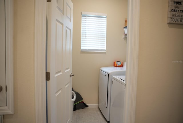 laundry area featuring independent washer and dryer and light tile patterned floors