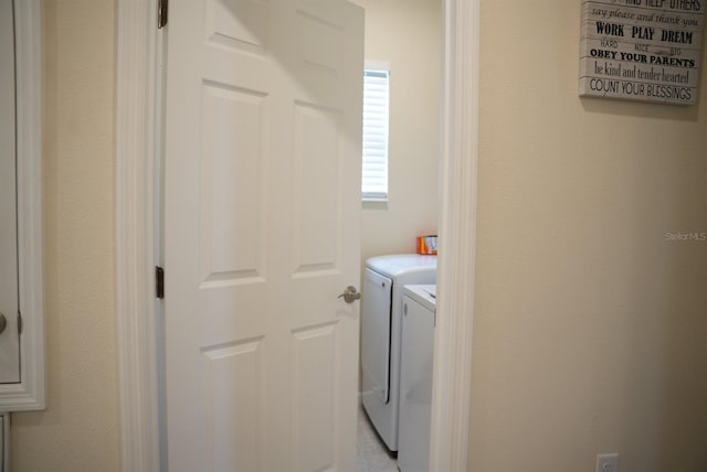 washroom with washer and dryer