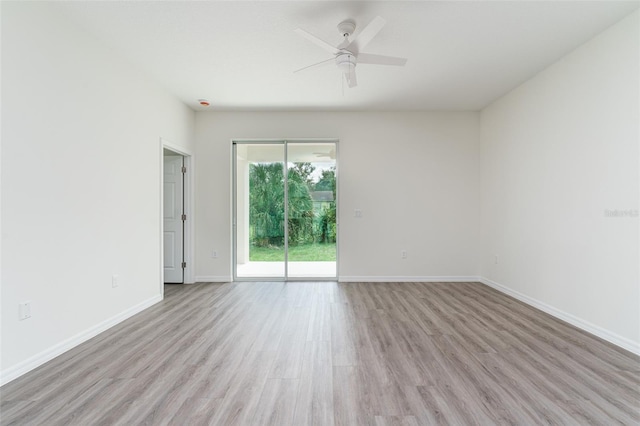 empty room with light wood-type flooring, baseboards, and a ceiling fan