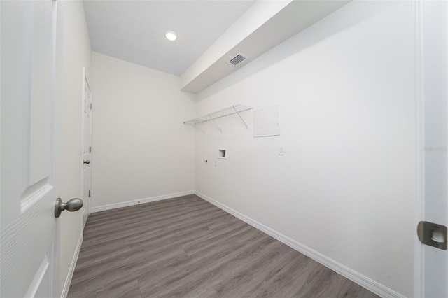 washroom featuring laundry area, wood finished floors, hookup for a washing machine, and visible vents