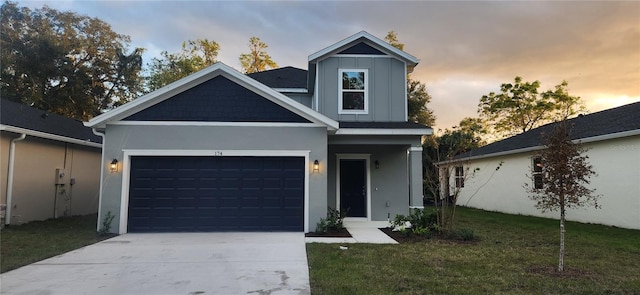 view of front facade with concrete driveway, a front lawn, board and batten siding, and an attached garage