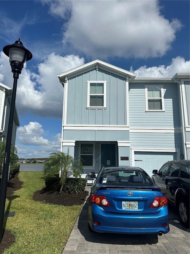 view of front of property featuring a garage and a front yard