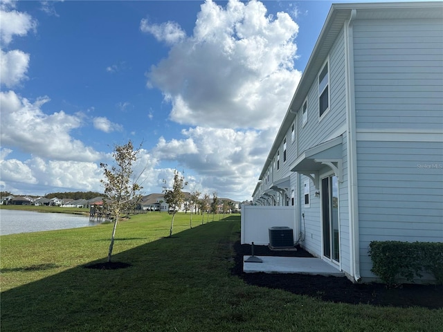 view of yard featuring a water view and cooling unit