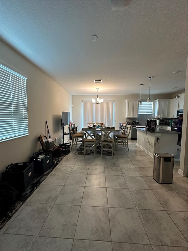 dining space featuring a notable chandelier and light tile patterned floors