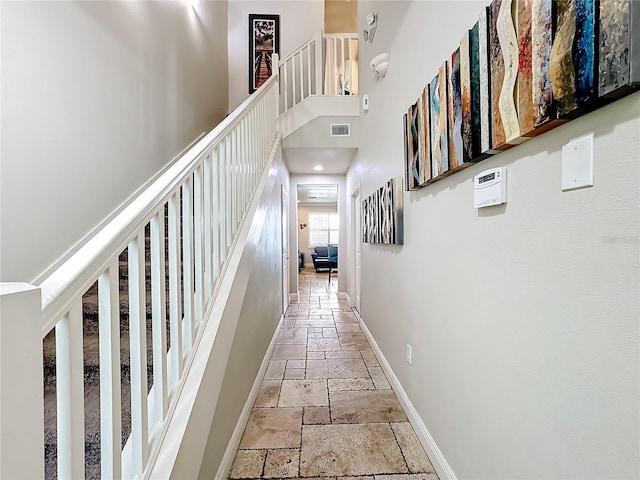 corridor featuring a towering ceiling