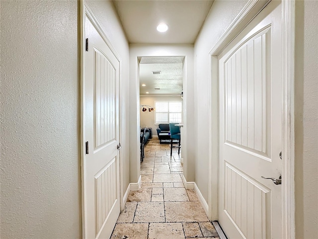 hallway with a textured ceiling