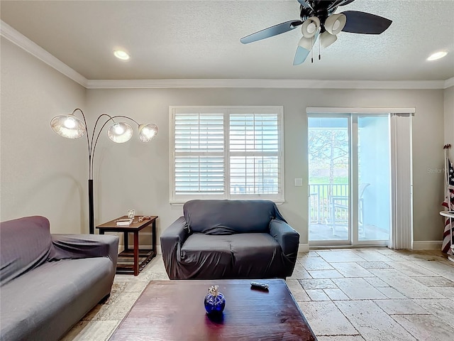 living room featuring ornamental molding, a textured ceiling, and ceiling fan