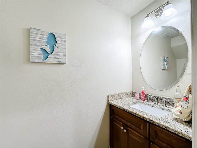 bathroom with vanity and a textured ceiling