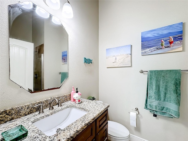 bathroom featuring vanity and toilet