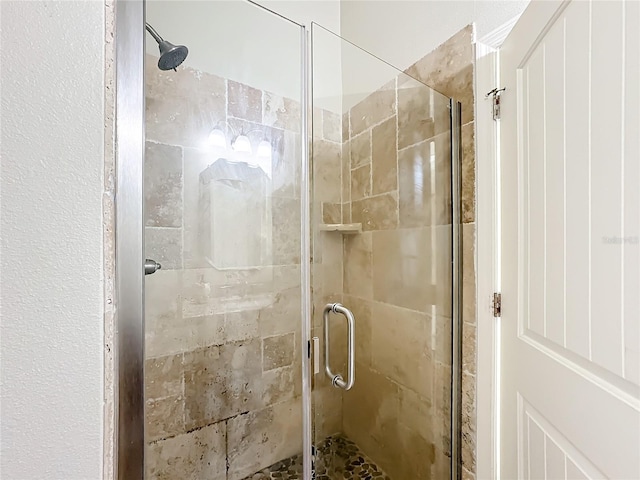 bathroom with a shower with shower door