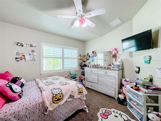 bedroom with ceiling fan, dark colored carpet, and a textured ceiling