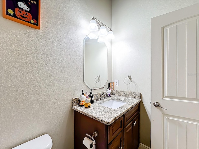 bathroom featuring toilet and vanity