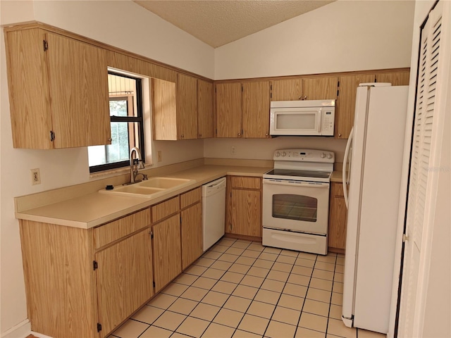 kitchen with sink, a textured ceiling, light tile patterned floors, white appliances, and lofted ceiling