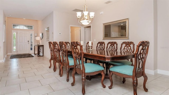 dining room with an inviting chandelier and light tile patterned floors