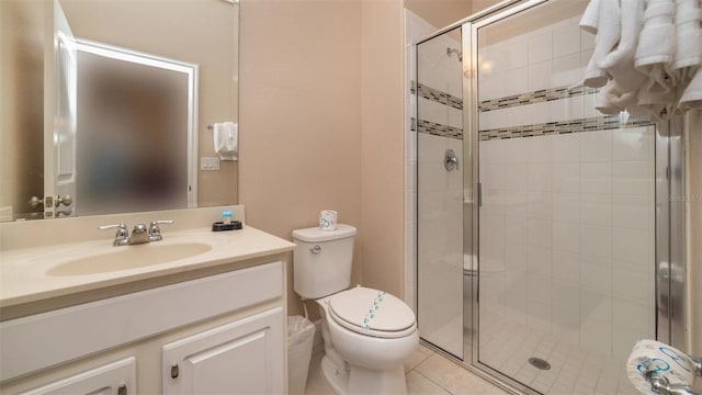 bathroom featuring walk in shower, tile patterned floors, vanity, and toilet