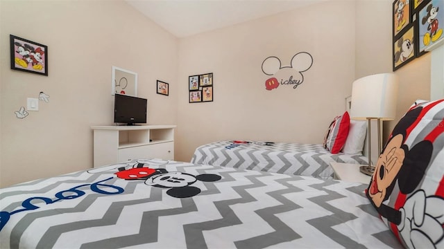 bedroom with lofted ceiling